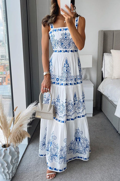 woman wearing a white and blue embroidered maxi dress