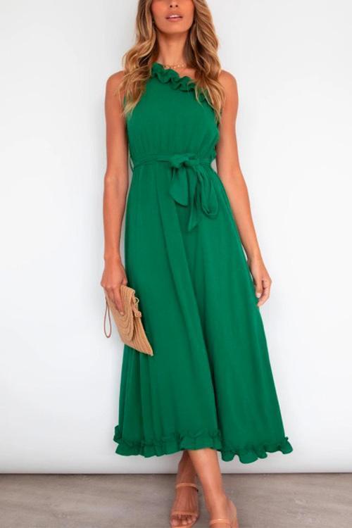 woman in green halter neck maxi dress with tie waist and ruffled hem