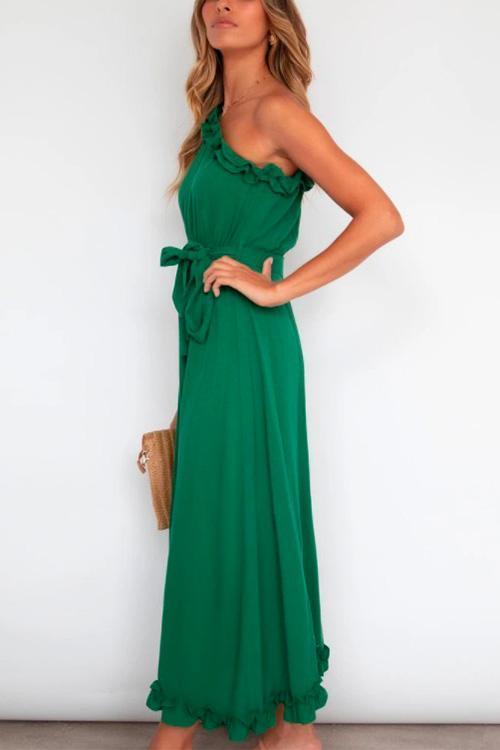 woman in green one-shoulder maxi dress with tie waist and ruffled hem