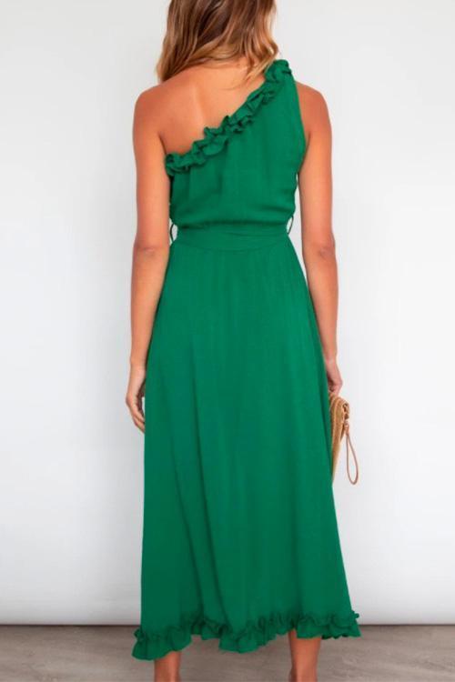 back view of woman in green maxi dress with tie waist and ruffled hem