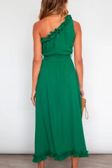 back view of woman in green maxi dress with tie waist and ruffled hem