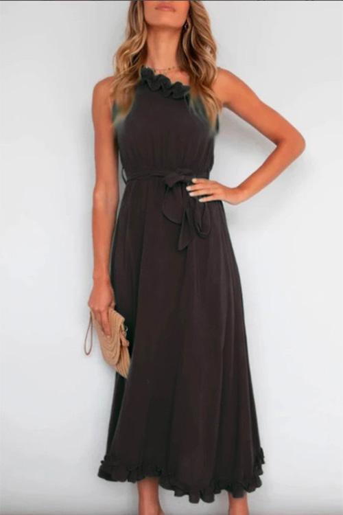 woman in dark grey halter neck maxi dress with tie waist and ruffled hem