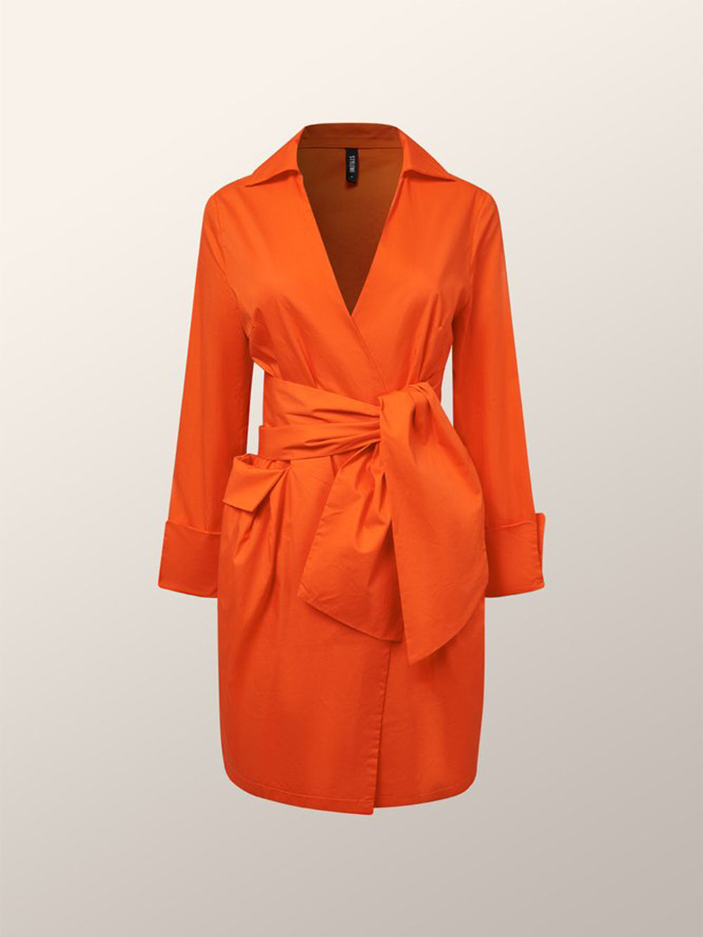 front view of an orange wrap dress with a tie waist and pleated skirt