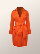 front view of an orange wrap dress with a tie waist and pleated skirt