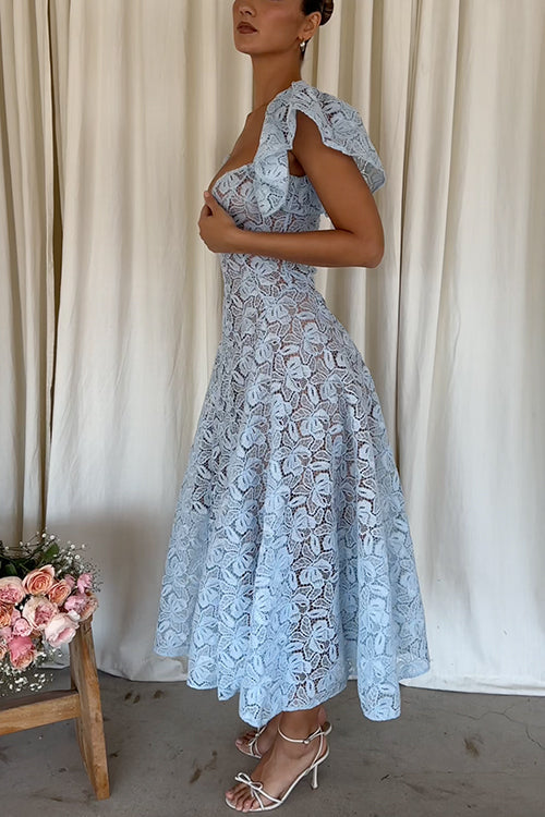 Side profile of a woman in a light blue lace midi dress