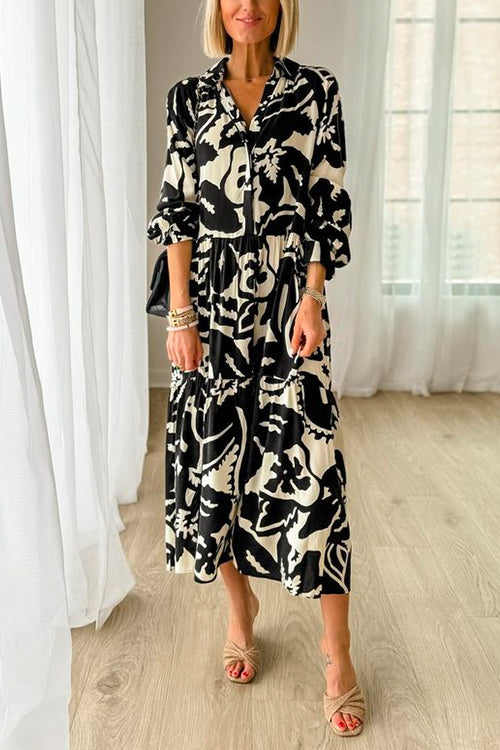 woman wearing a black and white floral print tiered maxi dress