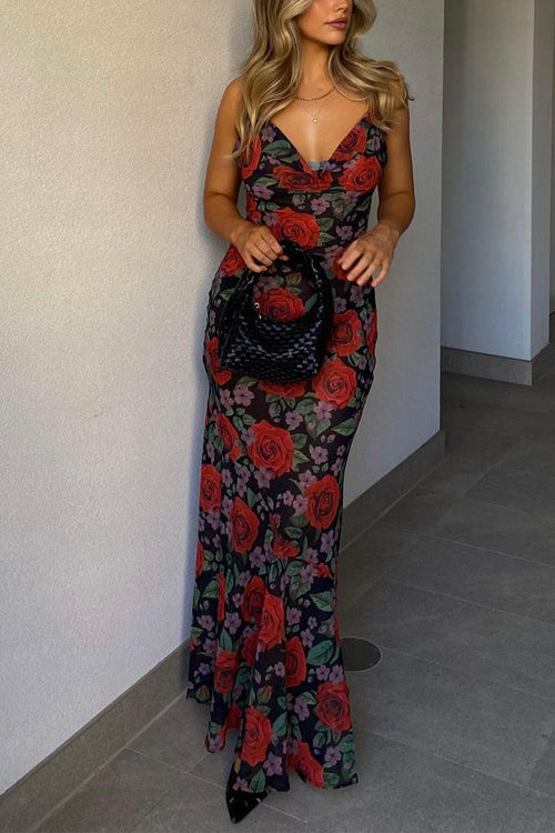 Full body shot of a woman in a floral maxi dress with spaghetti straps and a cowl neckline.