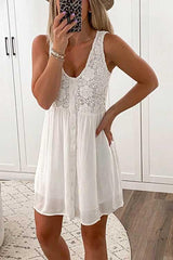 woman wearing a white sleeveless v-neck lace-trim button-down a-line dress