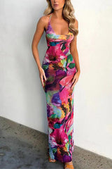 Woman in a colorful floral print backless maxi dress, front view
