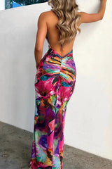 Woman in a colorful floral print backless maxi dress, view from behind