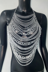 Silver chain halter top displayed on a black mannequin
