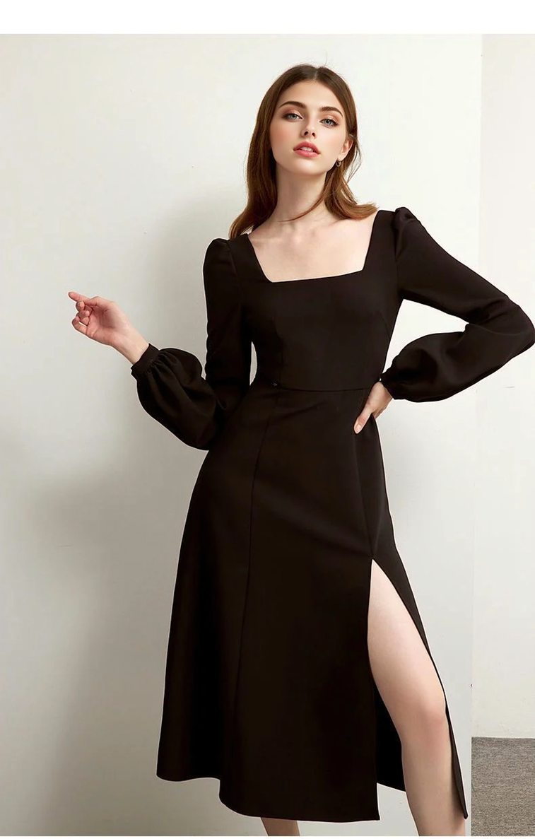 A woman posing in a black midi dress with a square neckline and puff sleeves, showing off the thigh-high slit.