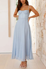 A woman in a light blue midi dress with her hands on her hips, showing the bodice detail.