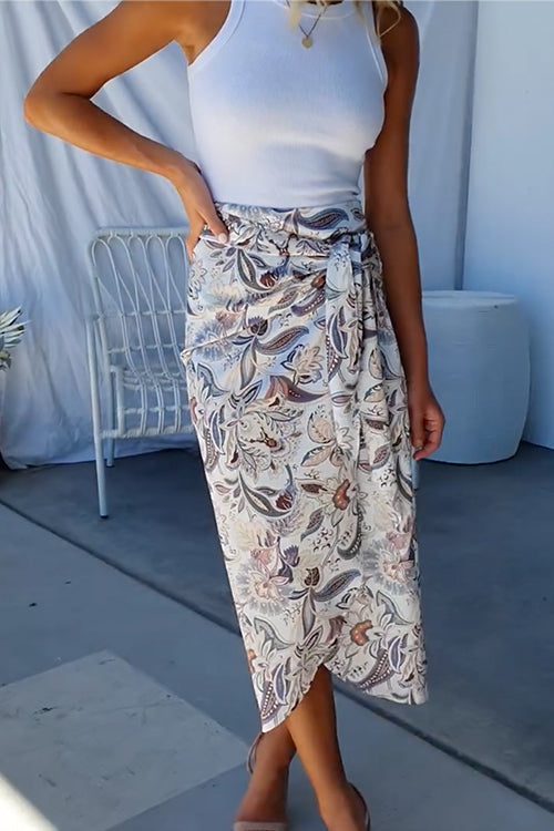 close-up of a woman's floral print midi wrap skirt with a tie waist
