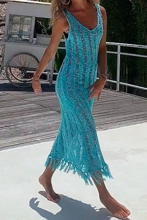 Woman in a blue crochet knit midi dress on a wooden deck