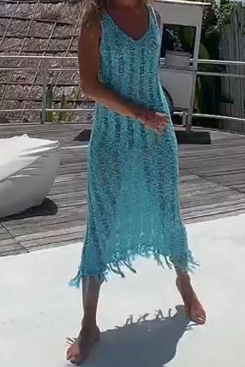 Woman wearing a blue crochet knit midi dress with fringe hem