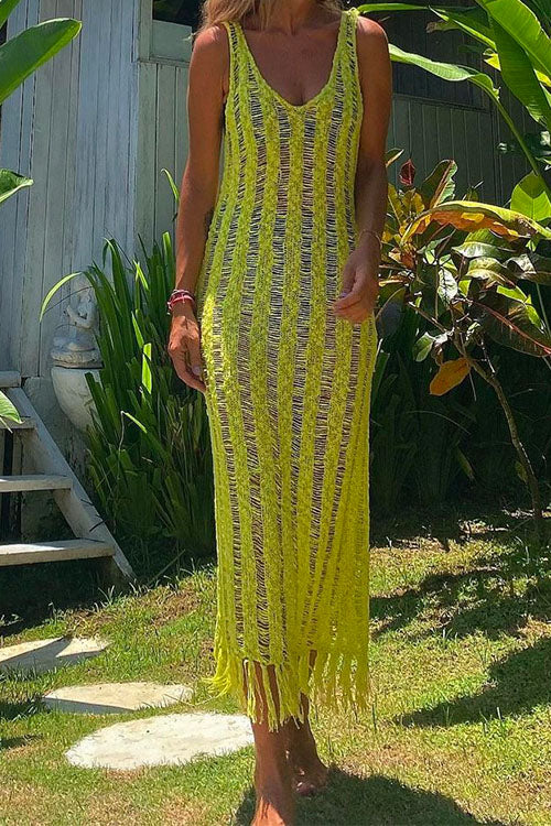 Woman wearing a yellow crochet knit midi dress with fringe hem