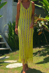 Woman wearing a yellow crochet knit midi dress with fringe hem