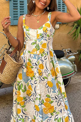 Close-up of a woman wearing a lemon-print dress and holding a straw bag.