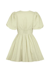 back view of a light green puff sleeve dress with a cinched waist and gathered skirt