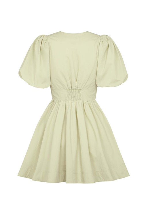 back view of a light green puff sleeve dress with a cinched waist and gathered skirt