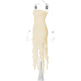 Side view of a cream strapless ruched midi dress with ruffled asymmetrical hemline and high slit on a mannequin.