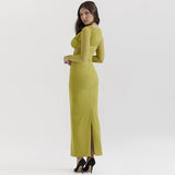 A rear view of a woman in a lime green, fitted maxi dress with a slit up the back.