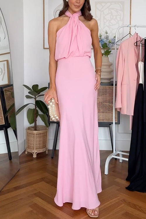 A full-body shot of a woman in a pink evening gown.