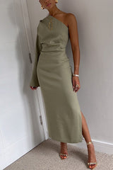 woman wearing a one-shoulder olive green dress with a high slit and gold accessories