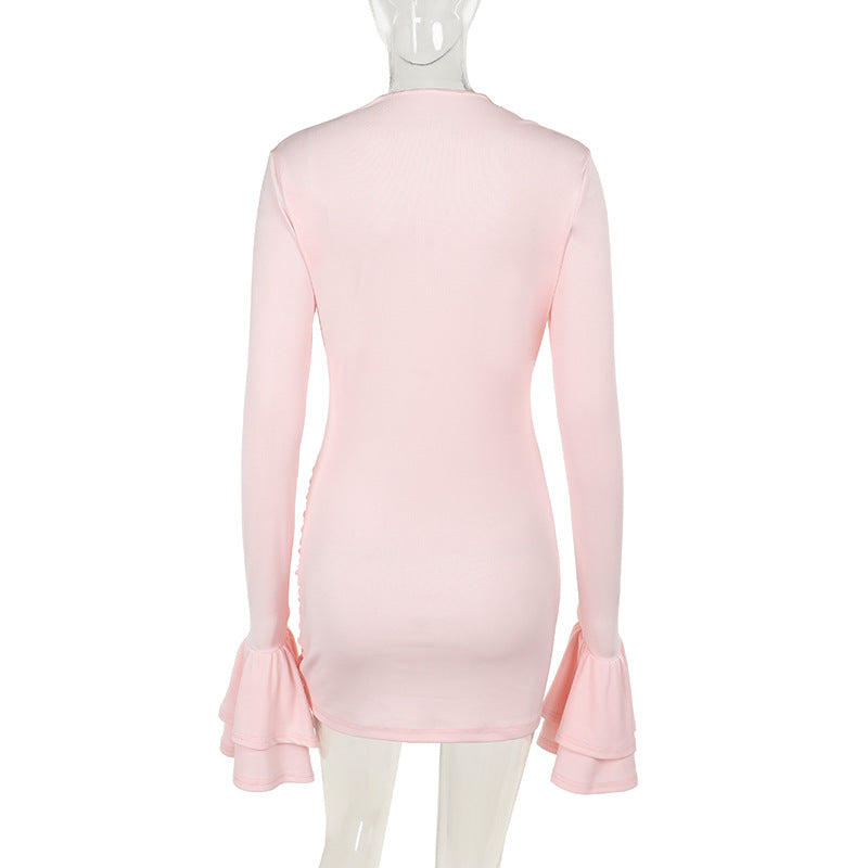 The back of a light pink long-sleeved ruched mini dress with ruffled sleeves on a mannequin.