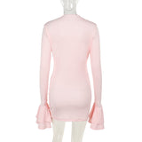 The back of a light pink long-sleeved ruched mini dress with ruffled sleeves on a mannequin.