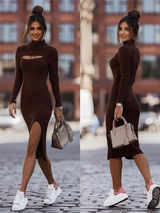 Woman in a brown ribbed knit dress with a cut-out and high slit, wearing white sneakers with pink accents and carrying a beige handbag.