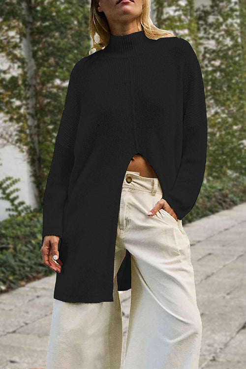 woman wearing a black long knit sweater with a high slit