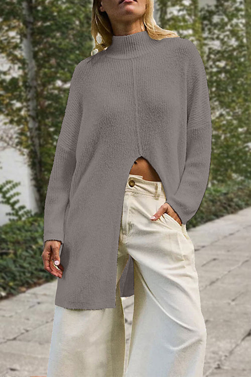 woman wearing a gray long knit sweater with a high slit