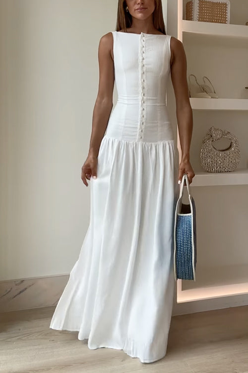 Woman in a white maxi dress and blue and white tote bag