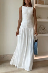Woman in a white maxi dress and blue and white tote bag