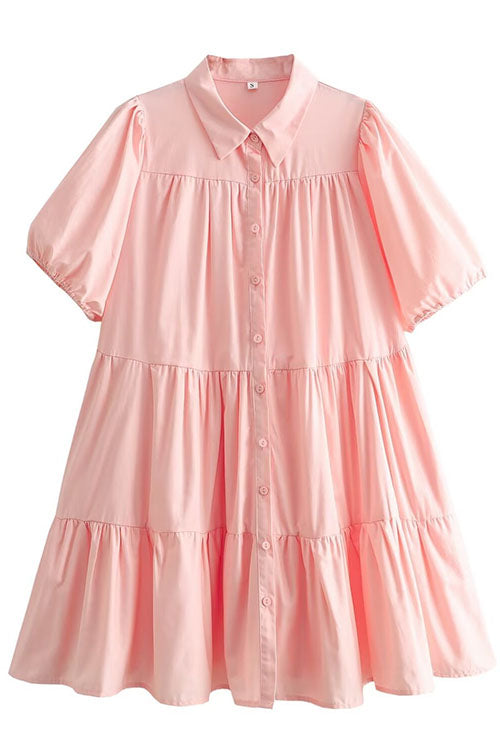 A pink tiered babydoll dress with puff sleeves and a collared neckline.