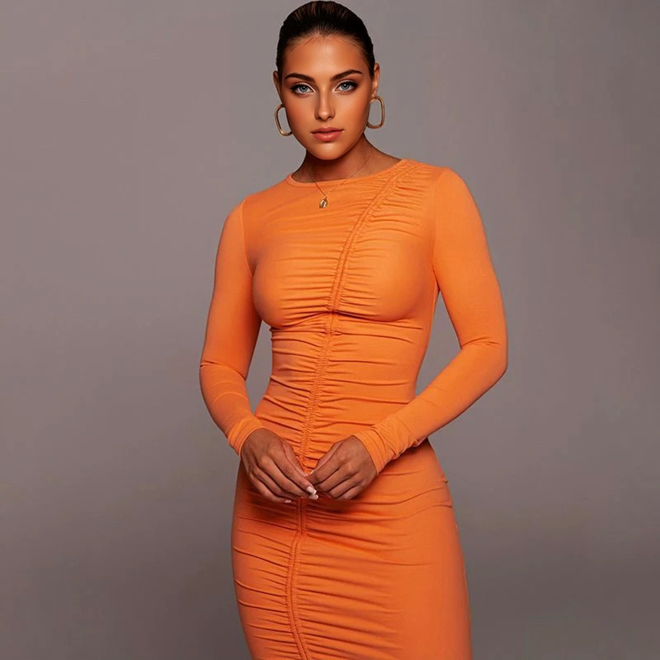 Woman in an orange ruched long-sleeve dress