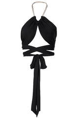 Black halter crop top with a cut-out front and gold chain detail, laid flat.