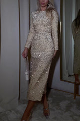 Woman in a champagne sequined midi dress with long sleeves and a round neckline