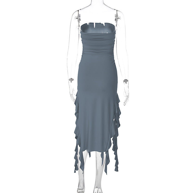 Mannequin displaying the back of a slate gray strapless ruched dress with ruffled fringe detailing.