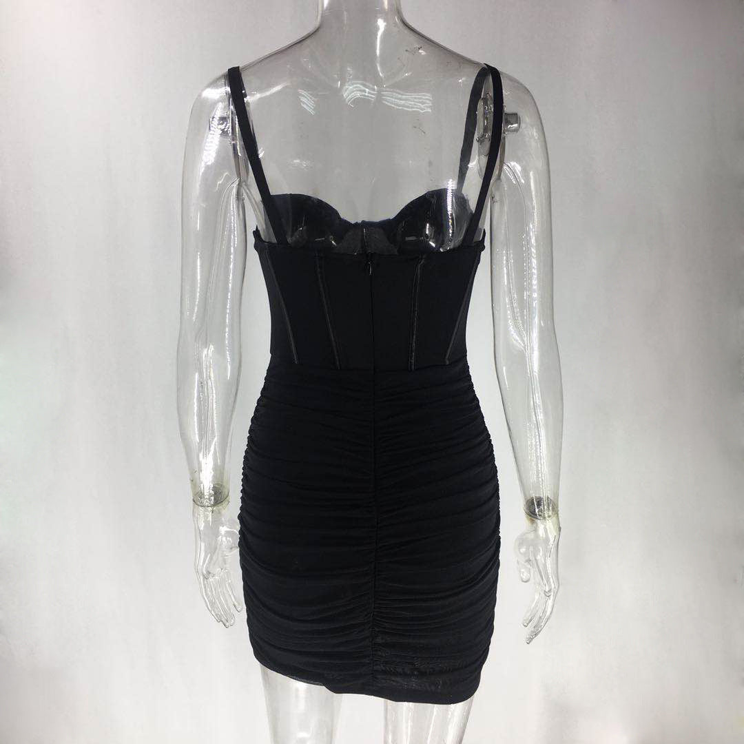 Back view of a black ruched mini dress with corset bodice on a mannequin