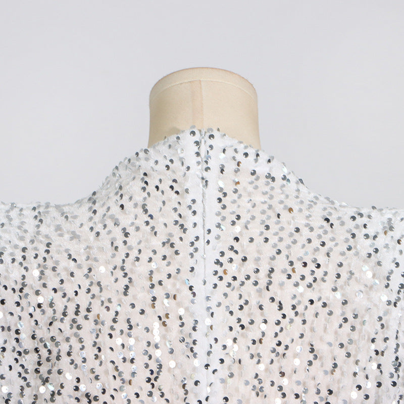 Close-up of the back of the high neckline of a white sequined dress on a mannequin.