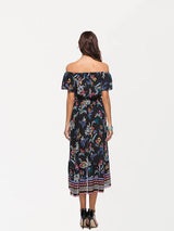 The back of a woman wearing a black off-the-shoulder dress with a floral print.