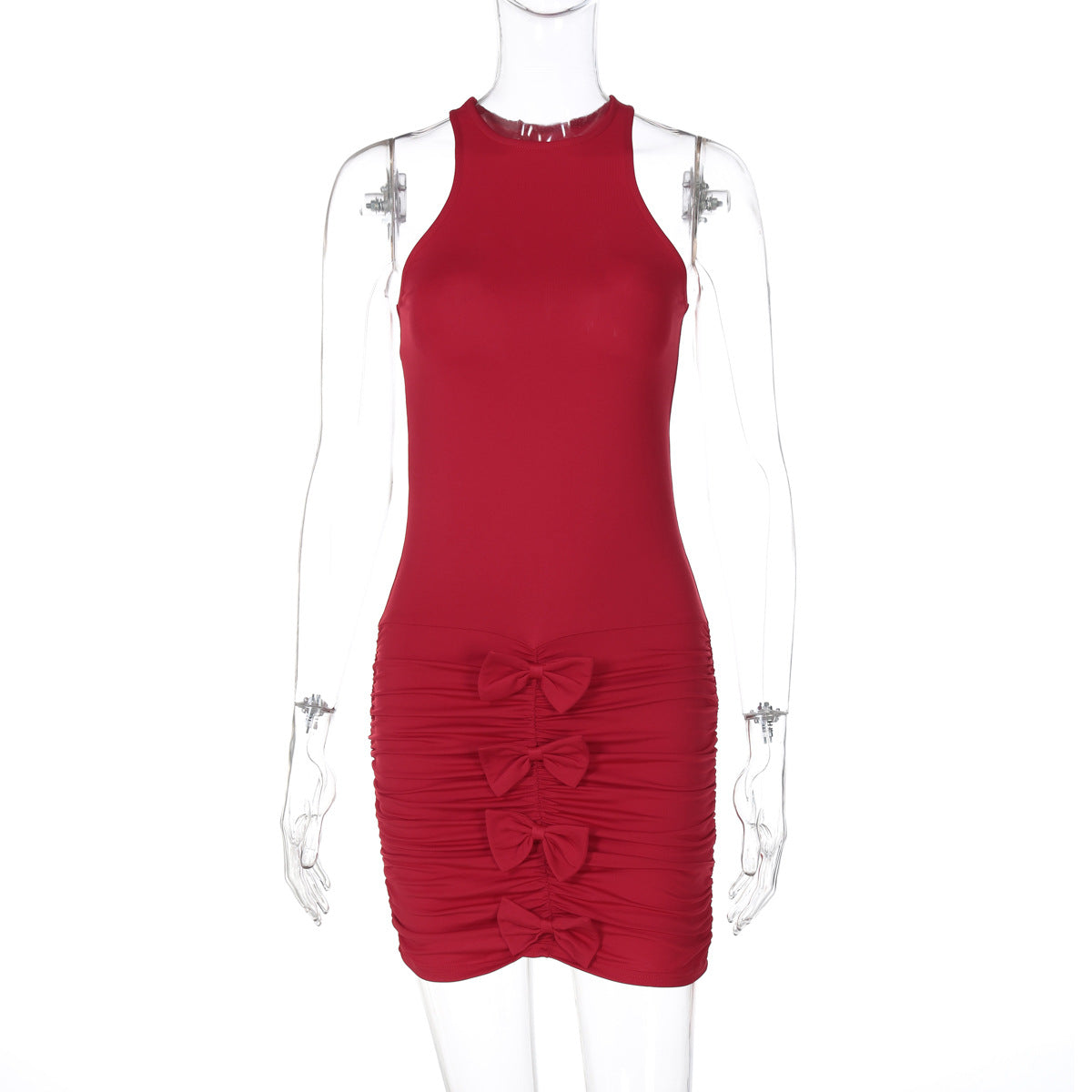 A red sleeveless mini dress with ruching and bow details displayed on a mannequin.
