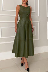 Woman wearing a sleeveless olive green faux leather midi dress with a belted waist and a flared skirt, front view