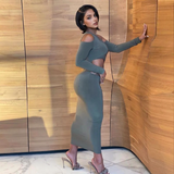 Woman posing in a gray one-shoulder maxi dress with cut-outs