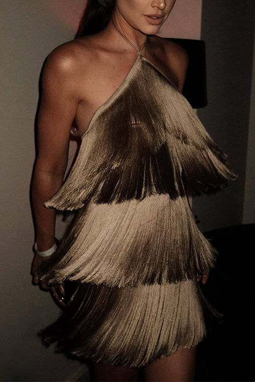 A woman in a tiered gold fringe dress