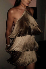 A woman in a tiered gold fringe dress