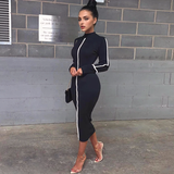 woman wearing a black midi dress with white stripes